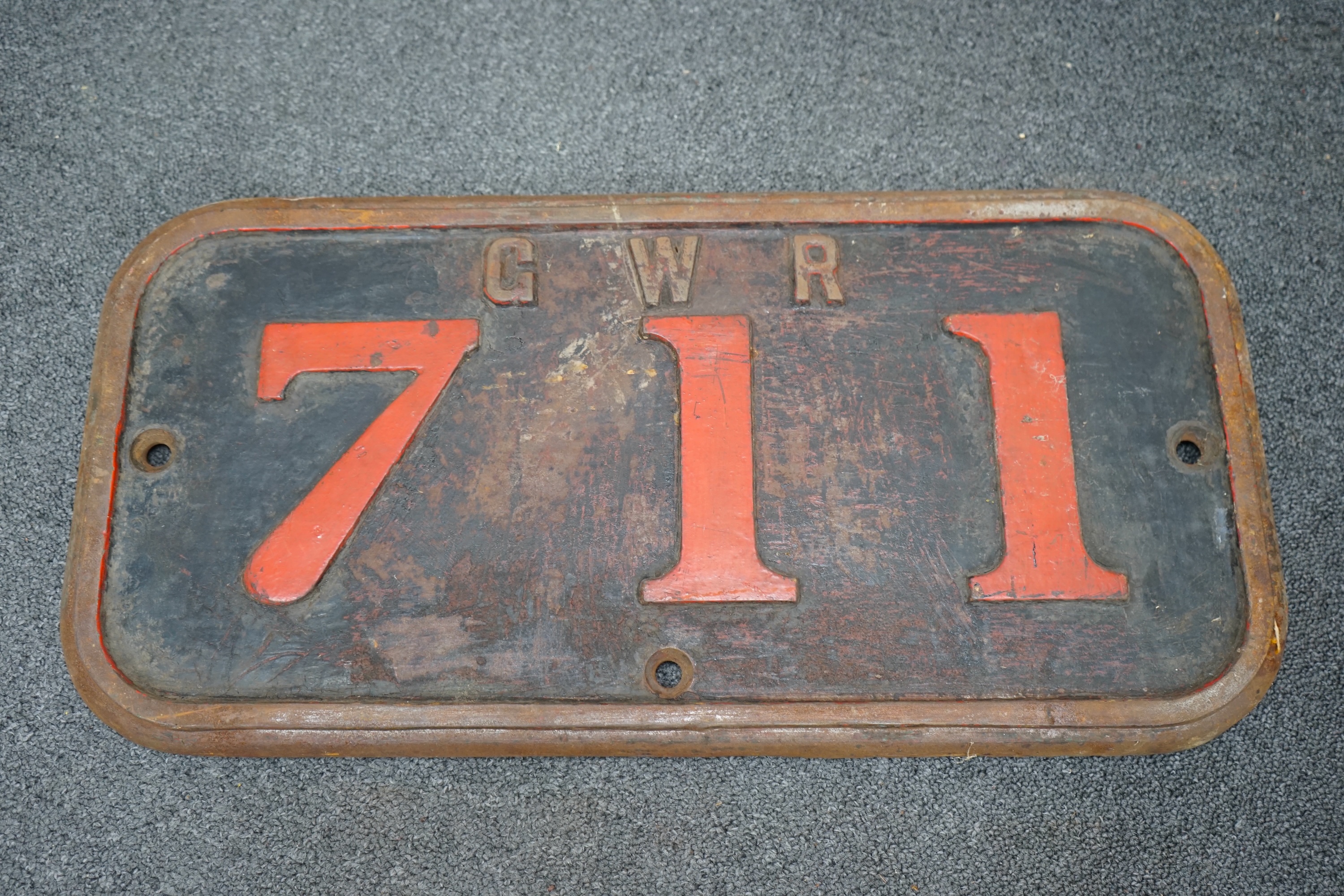 A cast iron GWR locomotive cab side number plate for a Class F 0-6-0ST locomotive, 711, built in 1890 for the Barry Railway, and withdrawn by the GWR in 1934 and sold to Powell Duffryn Coal Co., the locomotive was scrapp